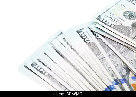 Stacks of hundred dollar bills arranged on a white surface in a neat fan display Stock Photo