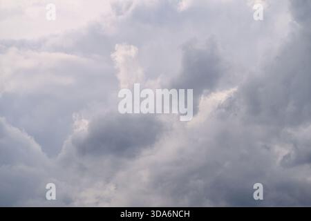 A truly stunning and mesmerizing view of a vast, cloudy sky, showcasing various shades and dramatic cloud formations Stock Photo