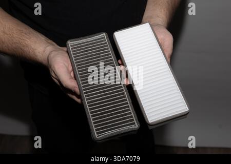 Heavily contaminated cabin air filter removed from a car, showing the need for replacement. Stock Photo
