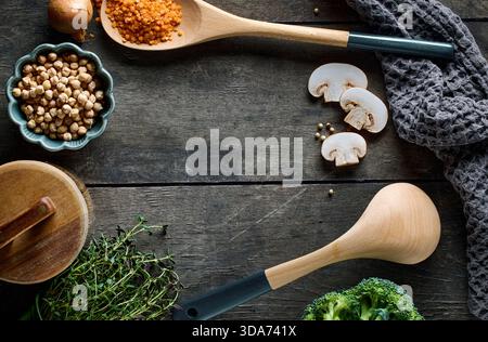 cooking tools on rustic dark wooden table surface, top view Stock Photo
