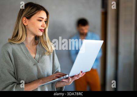 Multicultural couple working remotely, planning finances and investments online. Digital lifestyle Stock Photo
