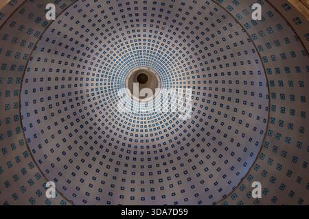 Symmetrical view of an illuminated dome ceiling with geometric patterns inside a basilica, Boulogne-sur-Mer. Stock Photo