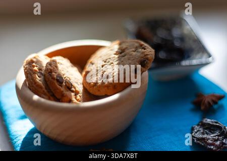 Fresh chocolate chip cookies in a wooden bowl Stock Photo