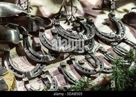 Handmade metal products from a blacksmith are on display at the New Year fair on Red Square near GUM. Horseshoes Stock Photo