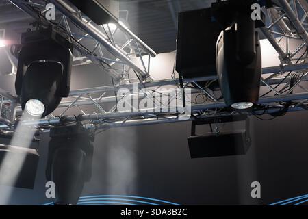 Lighting fixtures hanging on truss over the stage. Selective focus. Stock Photo