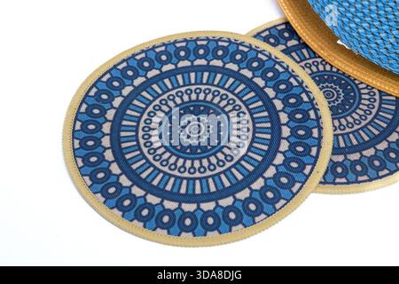 Blue circular placemats with geometric pattern on a white background. Stock Photo
