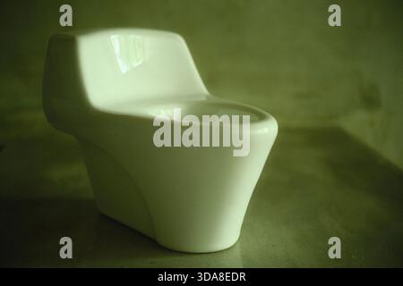 Miniature One-Piece Toilet Model on Display Stock Photo