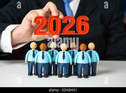 Office workers and 2026 in the hands of management. Business entering the new year 2026. Corporate planning, workforce alignment and organizational go Stock Photo
