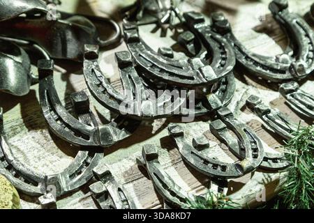 Handmade metal products from a blacksmith are on display at the New Year fair on Red Square near GUM. Horseshoes Stock Photo