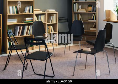 Chairs Forming Circle in Library Setting Preparing for Group Therapy Meeting Stock Photo