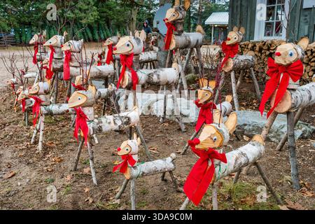Decorated Christmas deer logs at a Christmas tree farm Stock Photo
