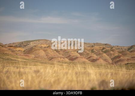 Scenic view of red-colored mountains illuminated by the warm glow of the setting sun. Stock Photo