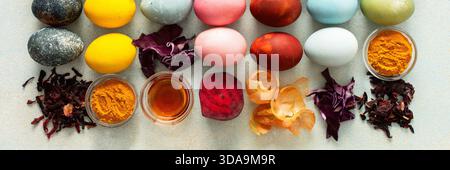 Brightly colored Easter eggs , showcasing various hues created from natural dye sources. Fresh ingredients are displayed alongside such as beets, turm Stock Photo