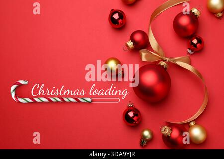 Christmas expectation. Candy cane as loading bar. Festive balls on red background, top view Stock Photo