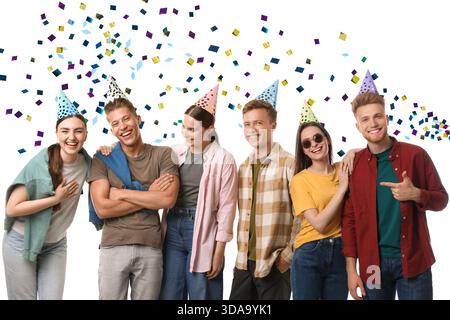 Happy Birthday party. Friends celebrating under falling confetti on white background Stock Photo