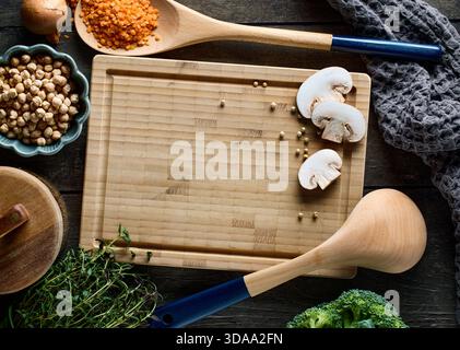 cooking tools on rustic dark wooden table surface, top view Stock Photo