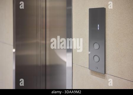 High-tech elevator panel featuring tactile buttons and illuminated screen, Advanced elevator interface showcasing touch sensitive controls alongside Stock Photo