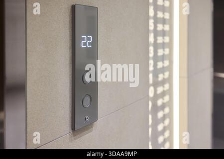High-tech elevator panel featuring tactile buttons and illuminated screen, Advanced elevator interface showcasing touch sensitive controls alongside Stock Photo