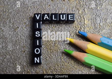 Concept of value and vision words arranged with on wooden letter blocks. Stock Photo