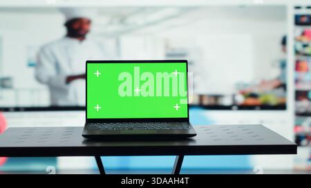 Chroma key notebook and video wall stacked with diverse entertainment media channels. Isolated screen laptop in front of digital backdrop displaying social networks feed activity Stock Photo