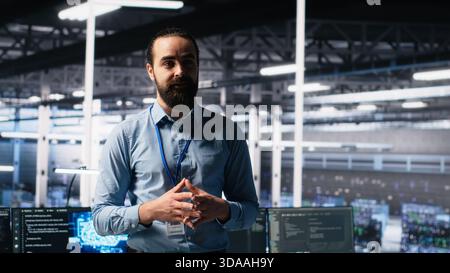 Data center manager presents AI technology to shareholders, demonstrating predictive maintenance capabilities. Man briefing investors on server hub artificial intelligence infrastructure, camera A Stock Photo