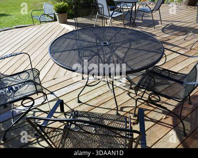 Outdoor patio dining area with metal tables and chairs Stock Photo