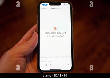 Close-up of a person's hand holding a smartphone and using the Opus 4 model within the Claude app from AI company Anthropic, Lafayette, California, May 22, 2025. (Photo by Smith Collection/Gado/Sipa USA) Stock Photo