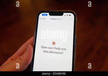 Close-up of a person's hand holding a smartphone and using the Opus 4 model within the Claude app from AI company Anthropic, Lafayette, California, May 22, 2025. (Photo by Smith Collection/Gado/Sipa USA) Stock Photo