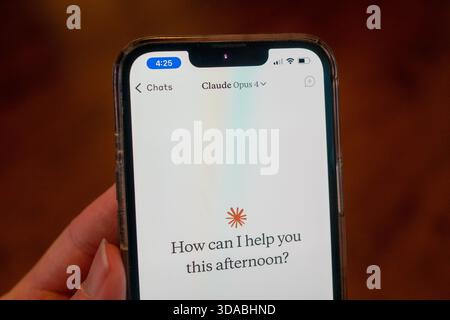 Close-up of a person's hand holding a smartphone and using the Opus 4 model within the Claude app from AI company Anthropic, Lafayette, California, May 22, 2025. (Photo by Smith Collection/Gado/Sipa USA) Stock Photo
