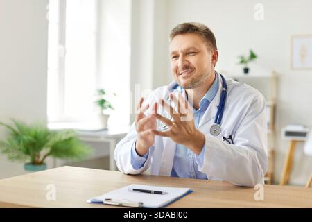 Portrait Of Happy Male Doctor Or Nurse Working In Hospital Office Stock Photo