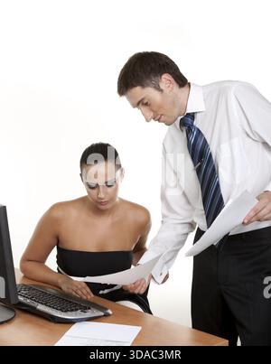 Two contemporary businesspeople discussing a document Stock Photo