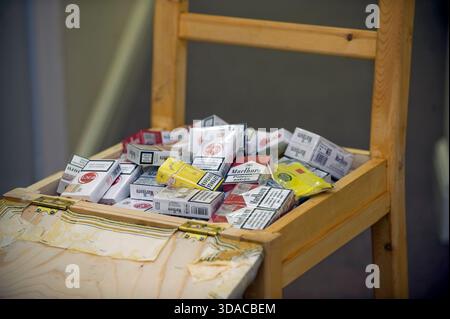 Contraband & Counterfeit cigarettes concealed in a chair, uncovered by  Trading Standards during a raid on a newsagents in the UK. Typically made  in the Russian states and China, the illicit products, often containing  contaminants such as vermin faeces 