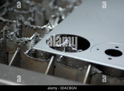 Workers guiding a computed guided lathe in an engineering factory. Stock Photo
