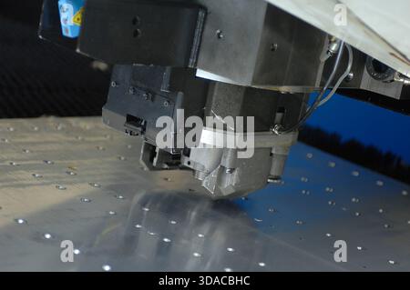 Workers guiding a computed guided lathe in an engineering factory. Stock Photo