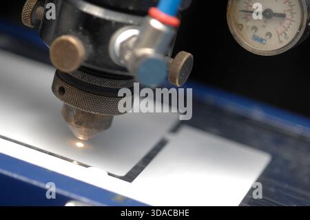 Workers guiding a computed guided lathe in an engineering factory. Stock Photo