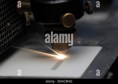 Workers guiding a computed guided lathe in an engineering factory. Stock Photo