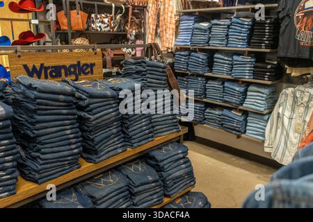 Stacks of Wrangler brand blue jeans on the shelves inside a Boot Barn store in the Mesilla Valley Mall in Las Cruces, New Mexico, USA Stock Photo