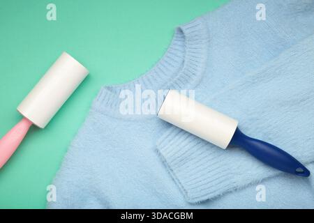 Lint roller on blue texture background to remove pet animal hair. Top view Stock Photo