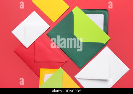 Composition with different envelopes and blank cards on red background, closeup Stock Photo