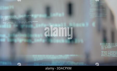 Floating code text overlay is hovering in flat design over facade with dark windows in technology Stock Photo