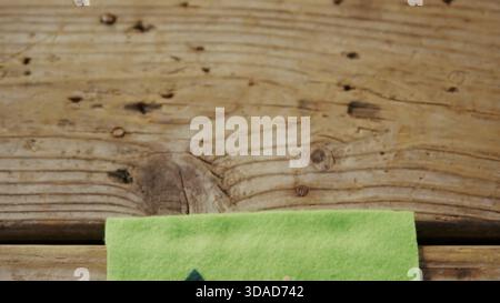 Green felt with printed shapes is lying on wood planks in flat design showing education theme Stock Photo