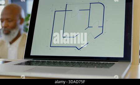 Silver laptop displaying blue floor plan is being shown in 3D render desk scene with plant Stock Photo