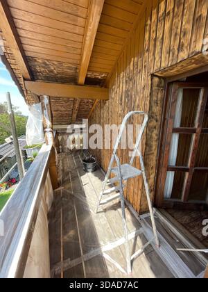 working on renovation work on the wooden facade of a house wall on an old farmhouse in Bavaria, Germany, Europe. Photo by Willy Matheisl Stock Photo