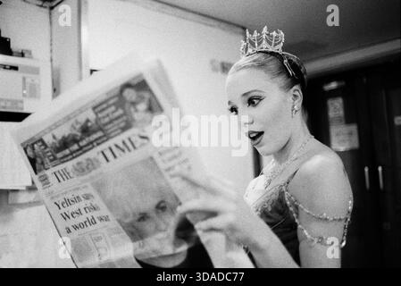 English National Ballet ballerina Joanna Maley reading The Times newspaper backstage at the Cambridge Arts Theatre, Cambridge, United Kingdom Stock Photo