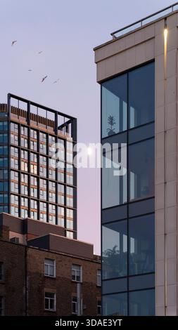 Urban geometry in Dublin: Moon suspended between contemporary towers and traditional brick foundations Stock Photo
