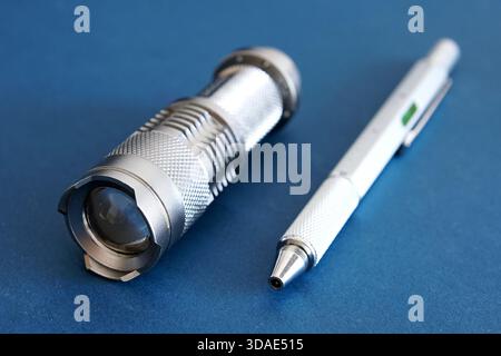 Products from aluminum, a flashlight and a writing pen. Stock Photo