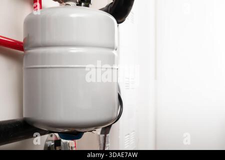 Water expansion tank for hot water heating systems. Close up. Pressurized expansion tank for closed loop hydronic heating system. Known as thermal exp Stock Photo