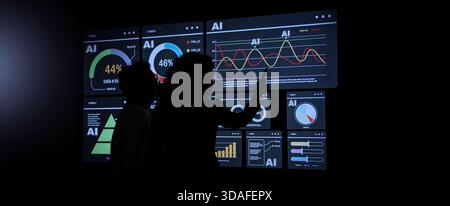 AI Using. Silhouetted analysts interact with a large AI data. AI Display charts graphs and analytics. Business team using futuristic AI interface visu Stock Photo