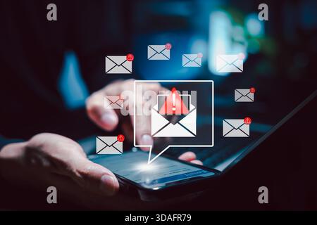 Email Security Threat Notification and Spam Warning Concept. Person using smart phone with icons of mail envelopes showing red warning Stock Photo