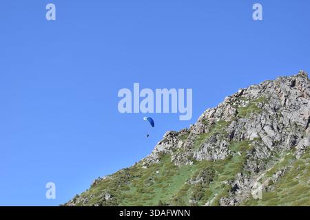 Hang glider flight over Trans-Ili Alatau Mountains, Kazakhstan Stock Photo